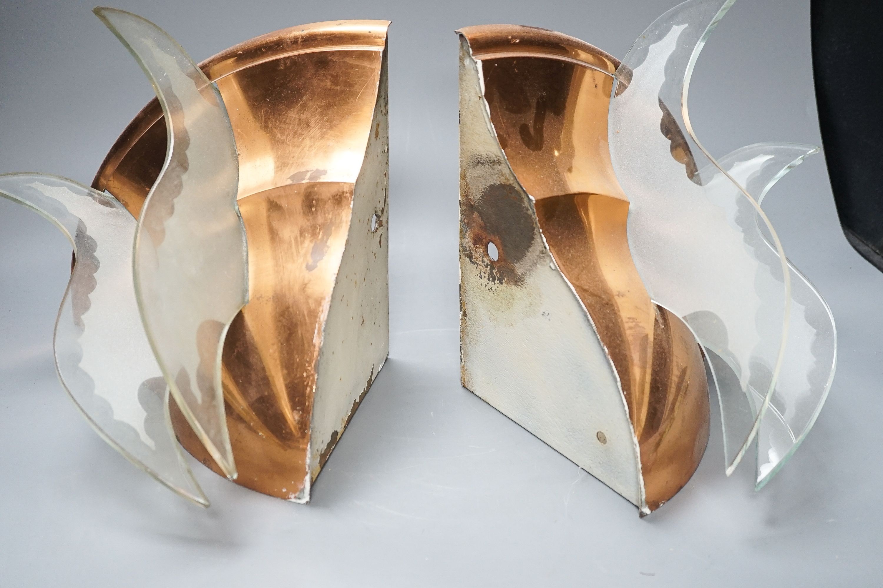 A pair of copper quarter wall lights